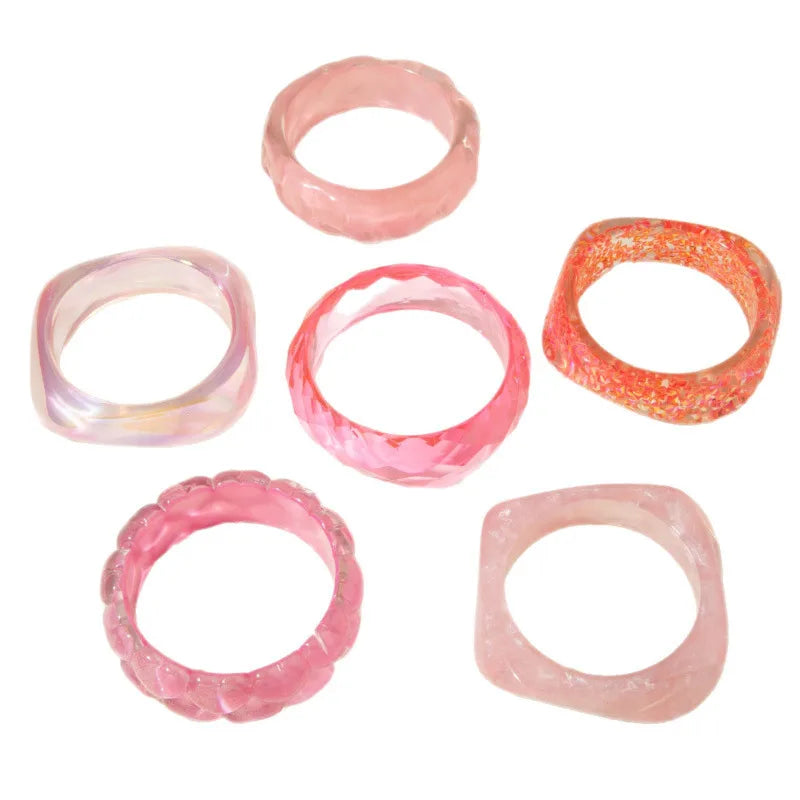 Set of pink and orange marbled rings on a white background