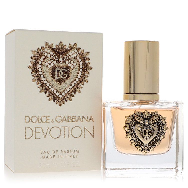 Dolce & Gabbana Devotion Eau de Parfum 1 oz spray bottle and elegant gold heart-adorned packaging on a clean white background, luxury designer women's fragrance.