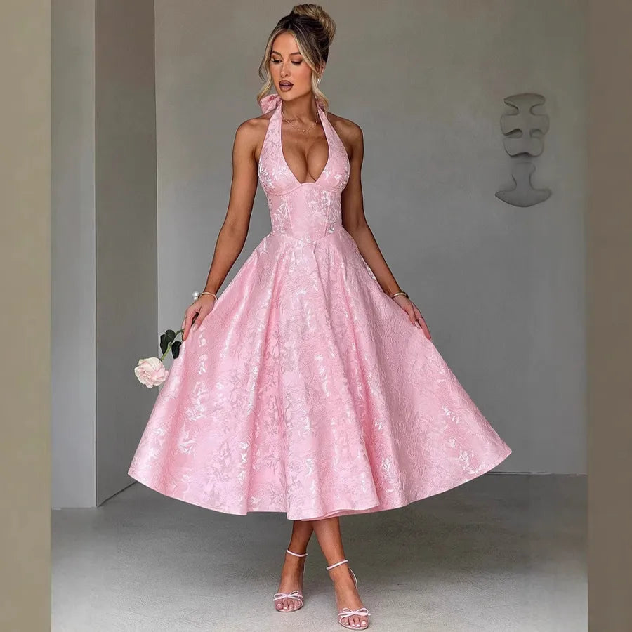Woman wearing a pink lace dress against a neutral background