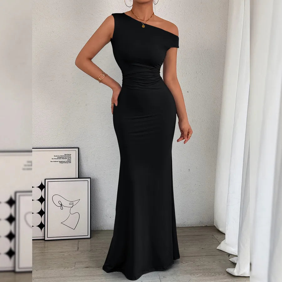 Woman wearing a black one-shoulder dress in a minimalistic room. Fish Tail Dress Sleeveless Asymmetrical Shoulder Neckline Waist Pleated Bodycon Dress Pure Color Elegant Style For Women