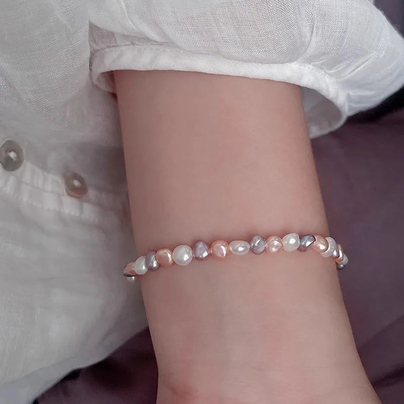 Pearl bracelet on a wrist with a blurred background
