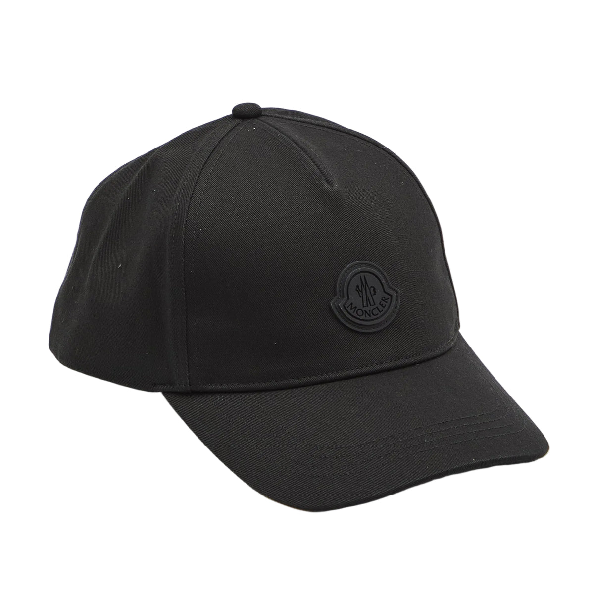 A black baseball cap with a tonal black embroidered circular logo on the front, photographed on a clean white studio background.