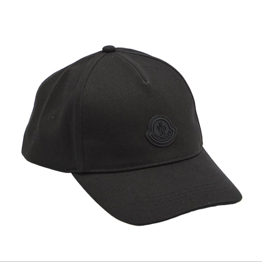 A black baseball cap with a tonal black embroidered circular logo on the front, photographed on a clean white studio background.
