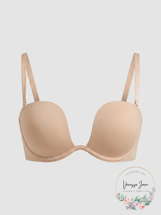 A beige wireless underwire bra with adjustable shoulder straps, shown against a light gray background with a 'Vanessa Jane' brand logo in the bottom right corner.