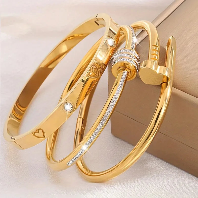 Two gold bangles with diamond accents on a light background