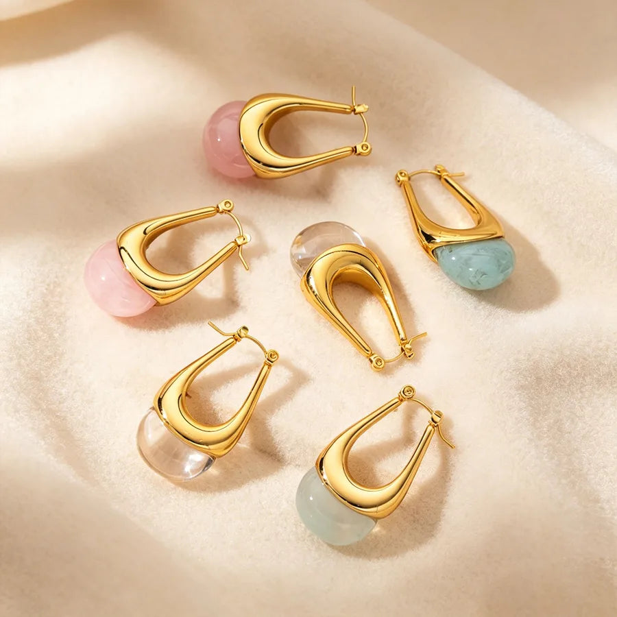 Gold hoop earrings with colorful gemstones on a beige surface 18k gold earrings,
18k gold plated earrings,
pvd gold earrings,
pvd plated jewelry,
hypoallergenic earrings,
stainless steel earrings,
304 stainless steel jewelry,
gold statement earrings,
irregular earrings,
geometric earrings,
abstract earrings,
modern earrings,
designer inspired jewelry,
minimalist jewelry,
fashion earrings,
women's earrings,
gold jewelry for women,
sensitive ears earrings,
nickel free earrings,
tarnish resistant jewelry