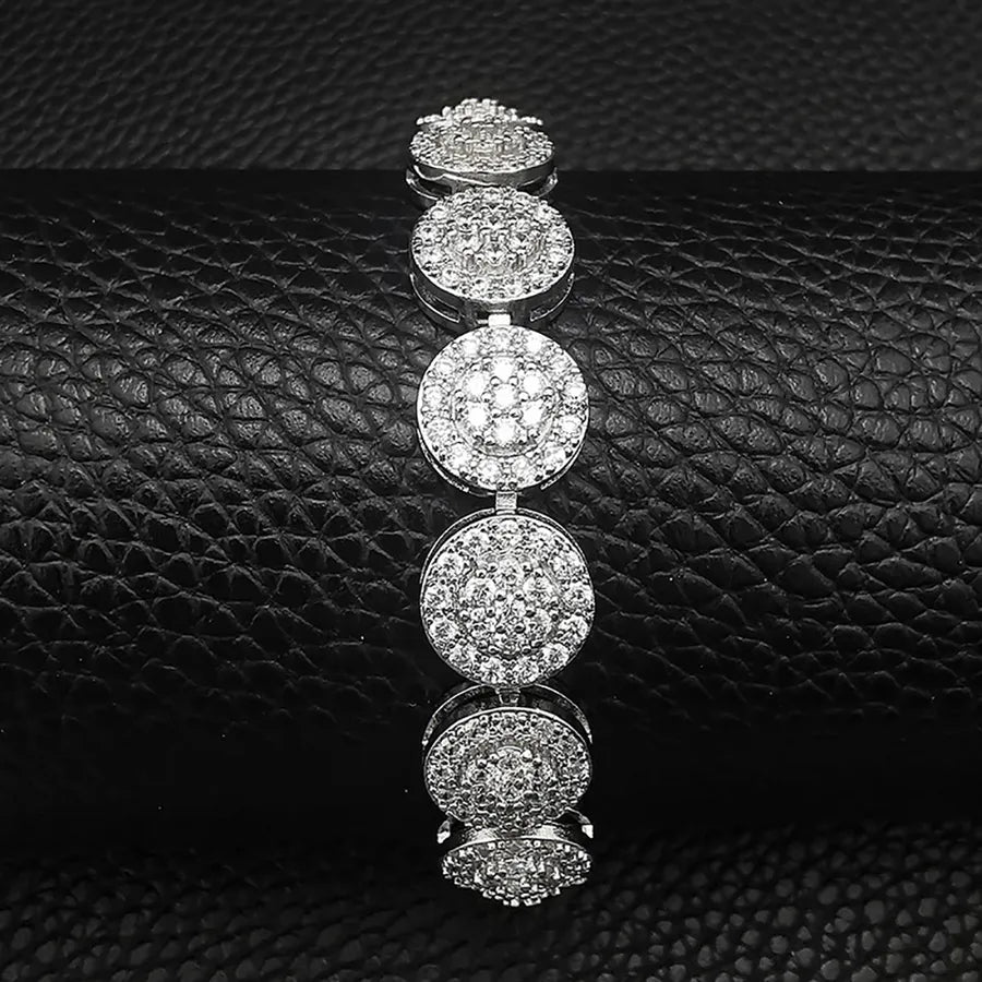 Silver bracelet with circular diamond designs on a black textured surface