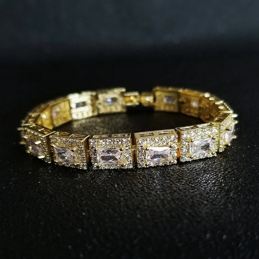 Gold bracelet with diamond accents on a black background