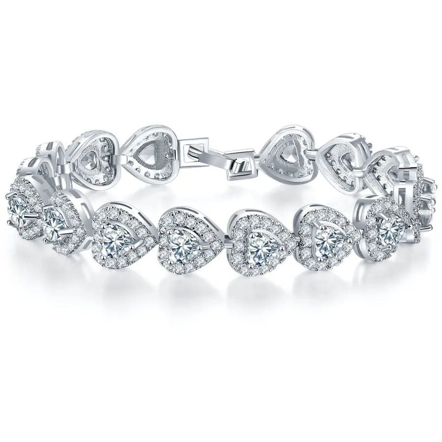 Silver bracelet with heart-shaped diamond charms on a white background