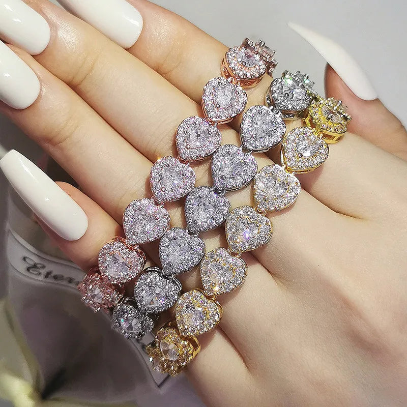Multiple diamond bracelets on a hand with a blurred background