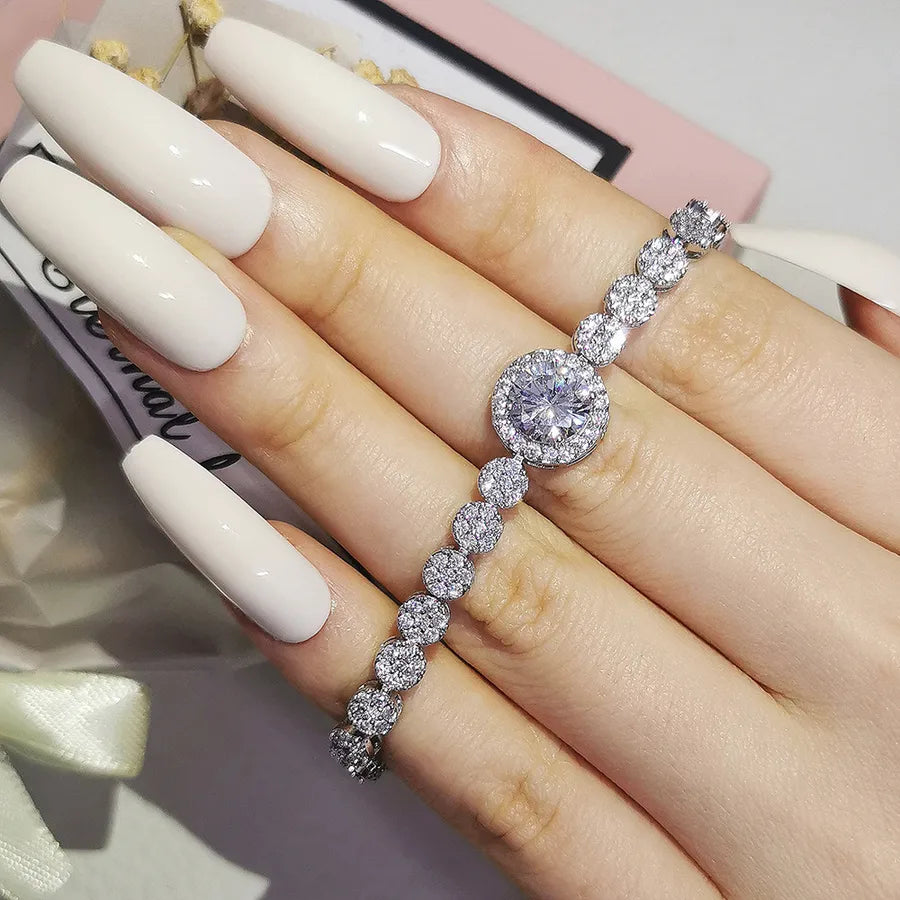 Diamond bracelet on a hand with white nail polish