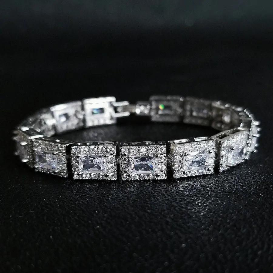 Silver bracelet with square-cut gemstones on a black background