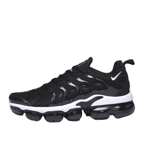 Black and white Nike sneakers with a prominent brand logo on a transparent background