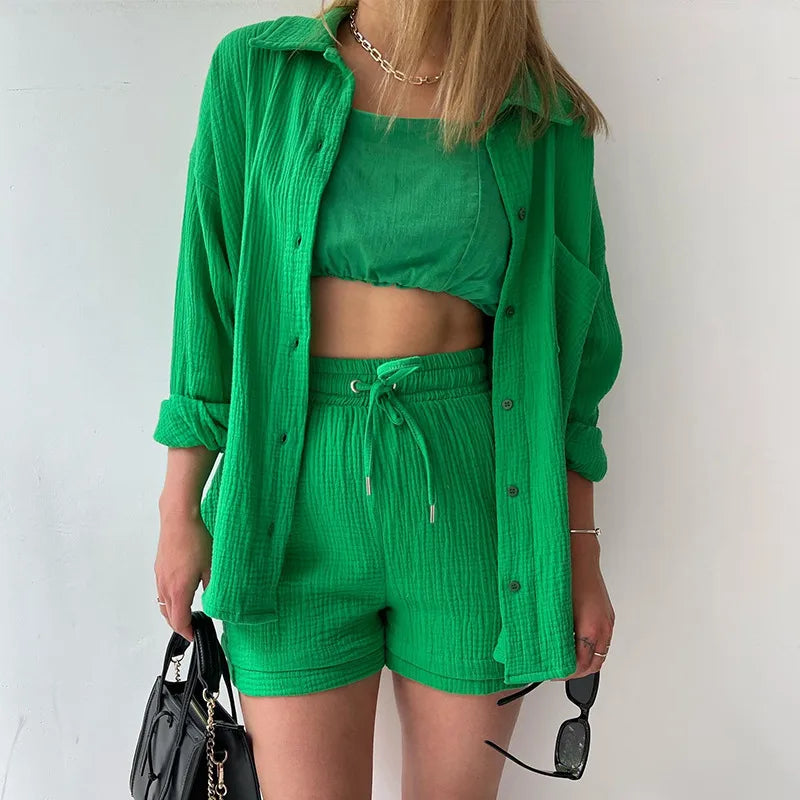 Person wearing a green outfit with a matching shirt, top, and green drawstring shorts against a white background.