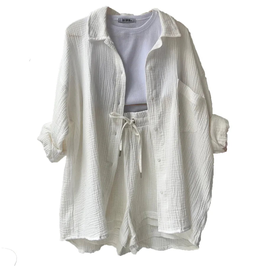 Light-colored ivory white long sleeve shirt with drawstring shorts on a white background