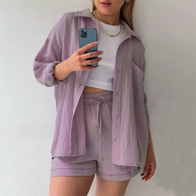 Person wearing a matching lavender outfit with a white top, taking a mirror selfie. Lavender long sleeve shirt and lavender drawstring shorts.