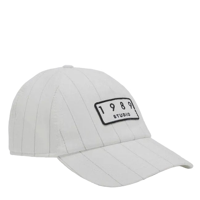 White cap with '1989 Studio' logo on a light gray background