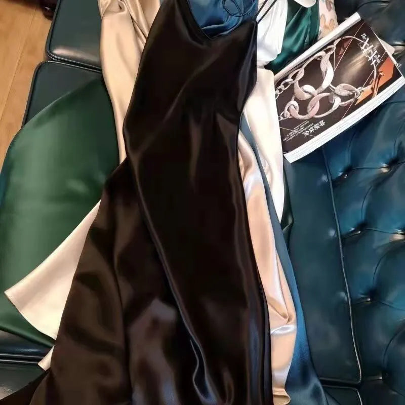 Close-up of a person wearing a black satin robe with a green leather chair in the background.