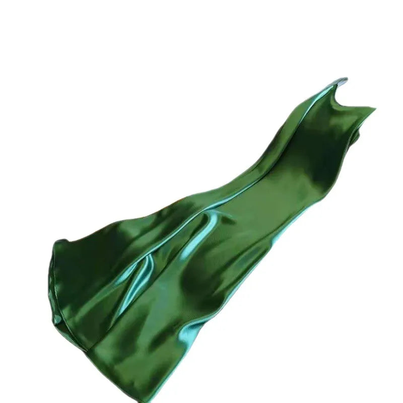 Green satin fabric on a white background