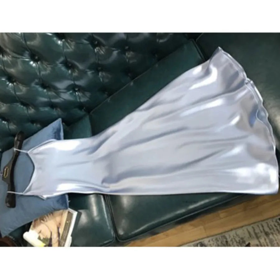White satin slip dress on a green couch
