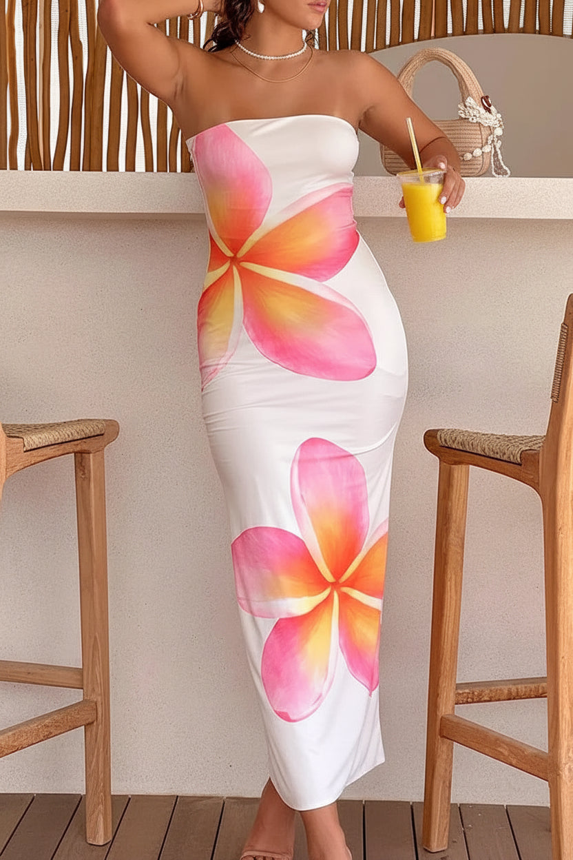 Woman in a strapless floral dress holding a beer bottle in a casual setting. Vacation resort dress