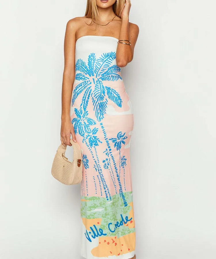 Woman wearing a strapless dress with palm tree design and 'Ville Cede' text. Vacation resort dress