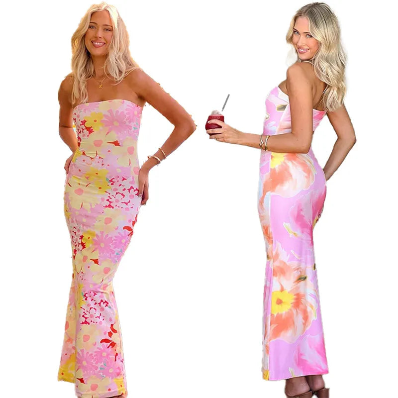 Woman wearing a floral strapless dress on a white background. Vacation resort dress