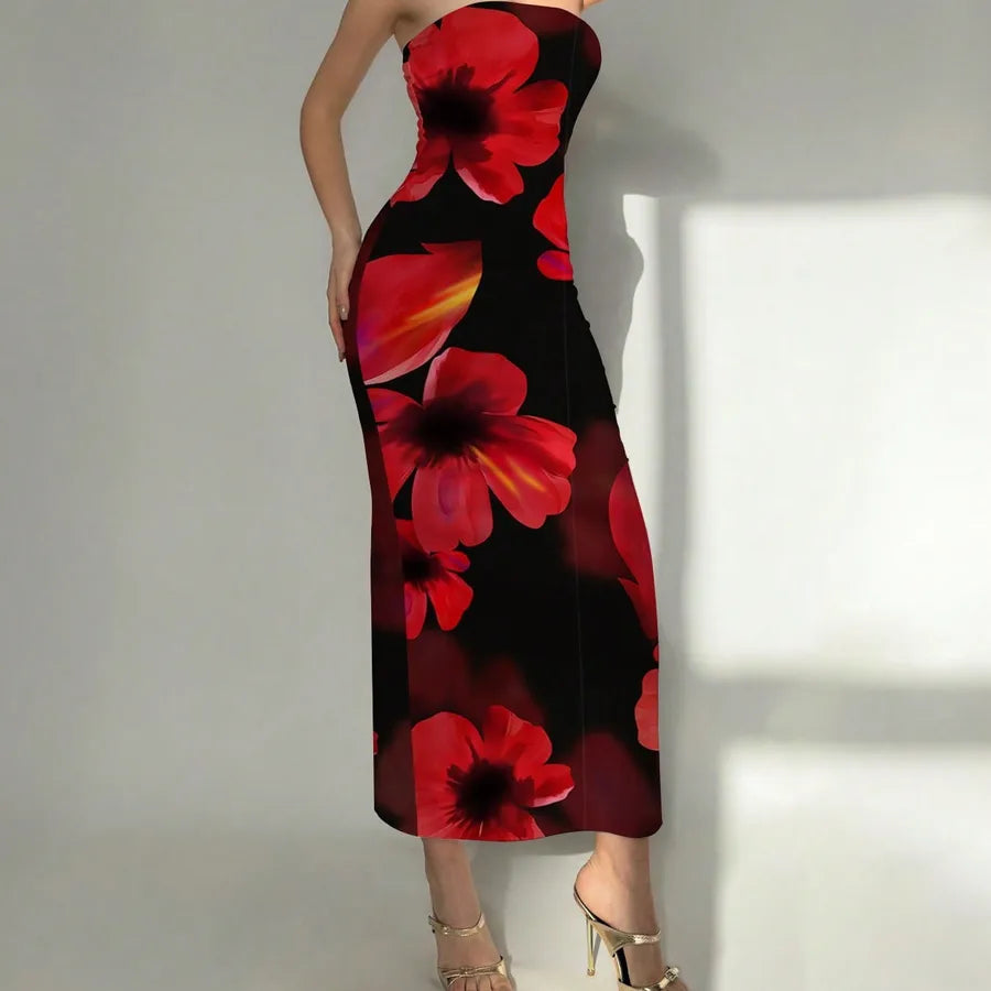 Woman wearing a strapless dress with red floral pattern on a plain background. Vacation resort dress
