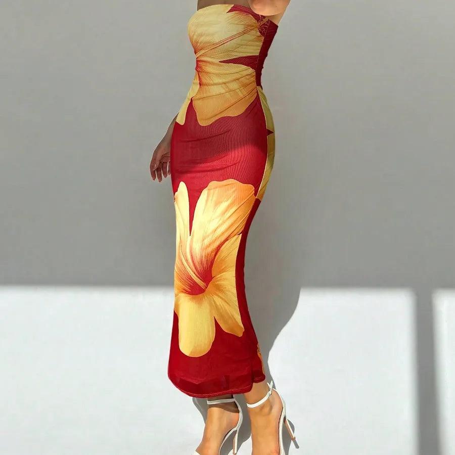 Red and yellow floral dress on a plain background. Vacation resort dress