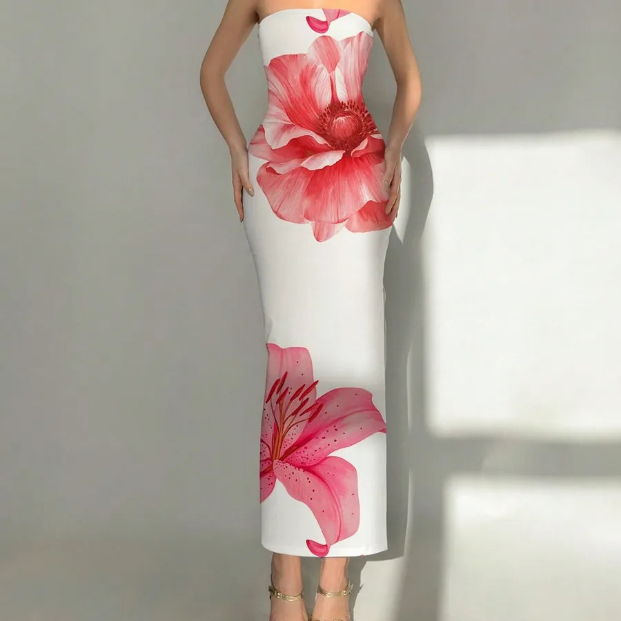 White strapless dress with pink floral design on a plain background. Vacation resort dress