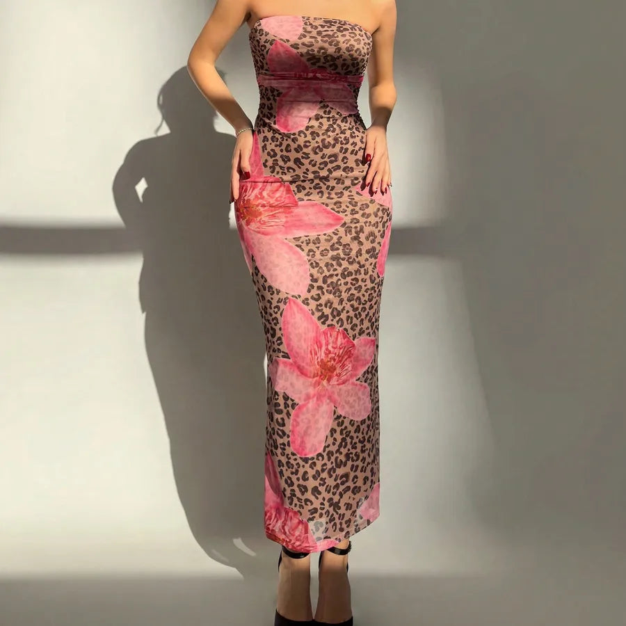Woman wearing a strapless dress with leopard print and pink floral design against a plain background. Vacation resort dress
