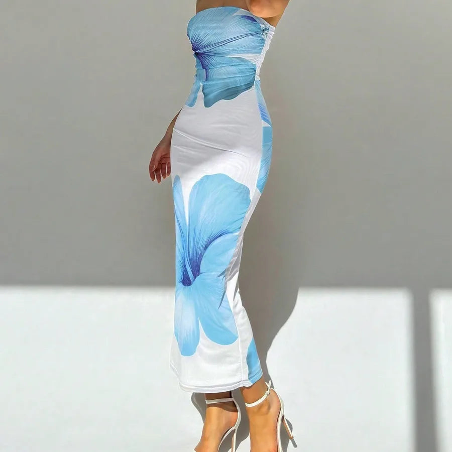 White dress with blue butterfly patterns on a plain background. Vacation resort dress