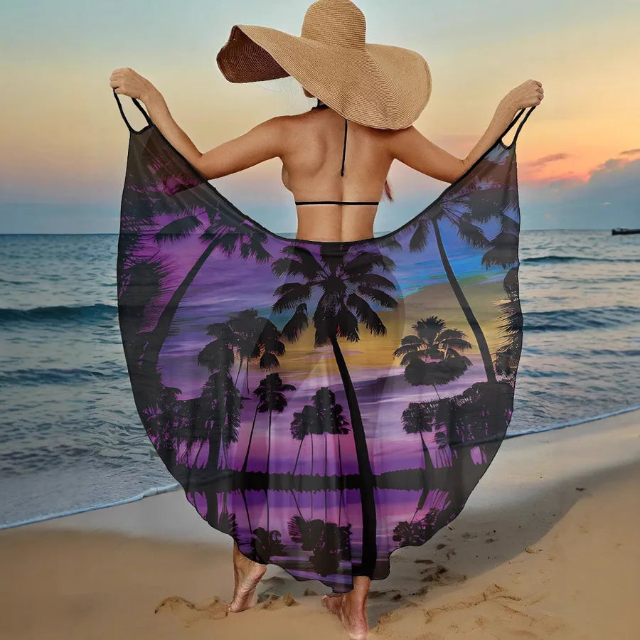 Woman on a beach with a purple palm tree patterned sarong.