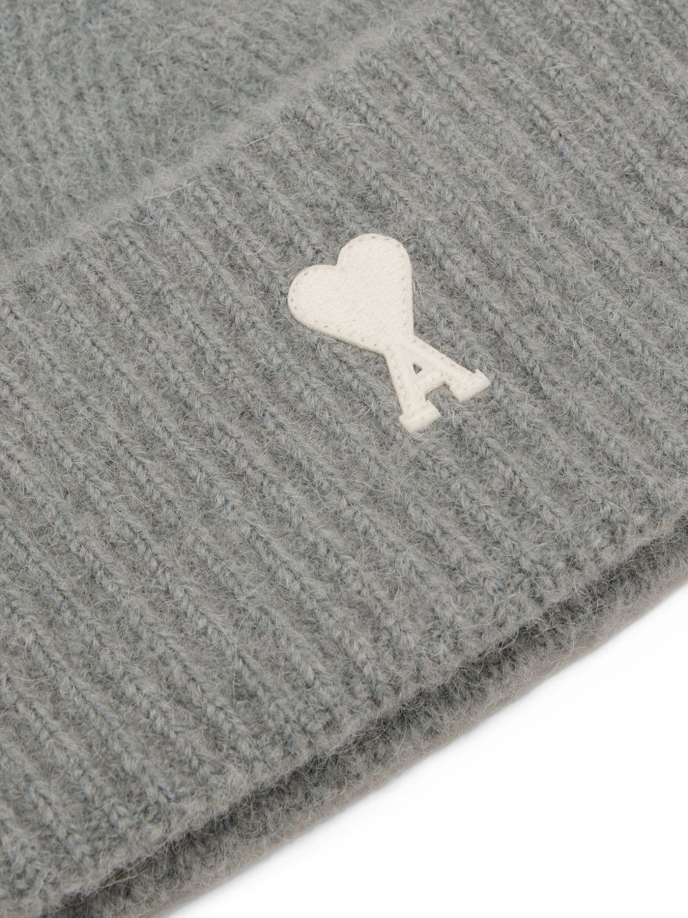 Gray textured fabric with a white heart-shaped logo on a white background