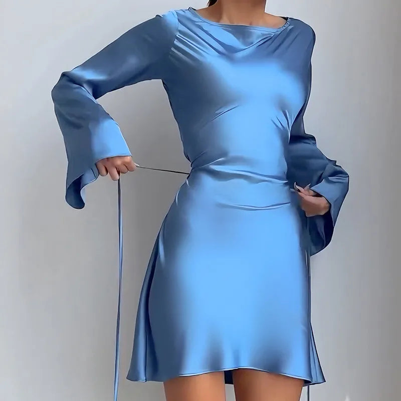 Blue dress with long sleeves on a plain background