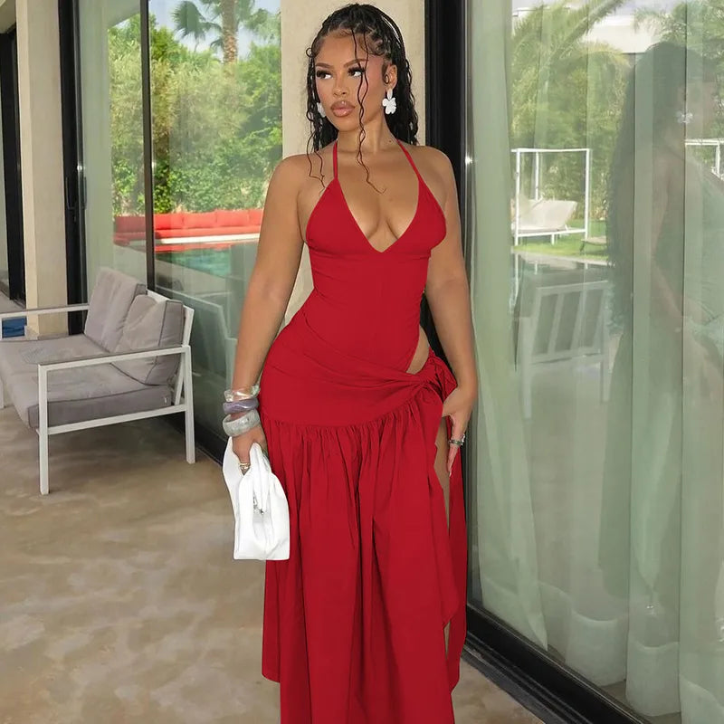 Woman in a red dress standing in a modern indoor setting with glass walls. halter skirt set, two piece outfit women, skirt co ord set, matching set women, bodycon skirt set, sexy vacation outfit, halter neck outfit, asymmetrical outfit, date night outfit, clubwear women, birthday outfit women, resort wear women, vacation clothes women, slim fit skirt set, elegant two piece set, womens co ord set, sexy matching set, summer outfit women, luxury fashion women, trendy two piece outfit swimsuit