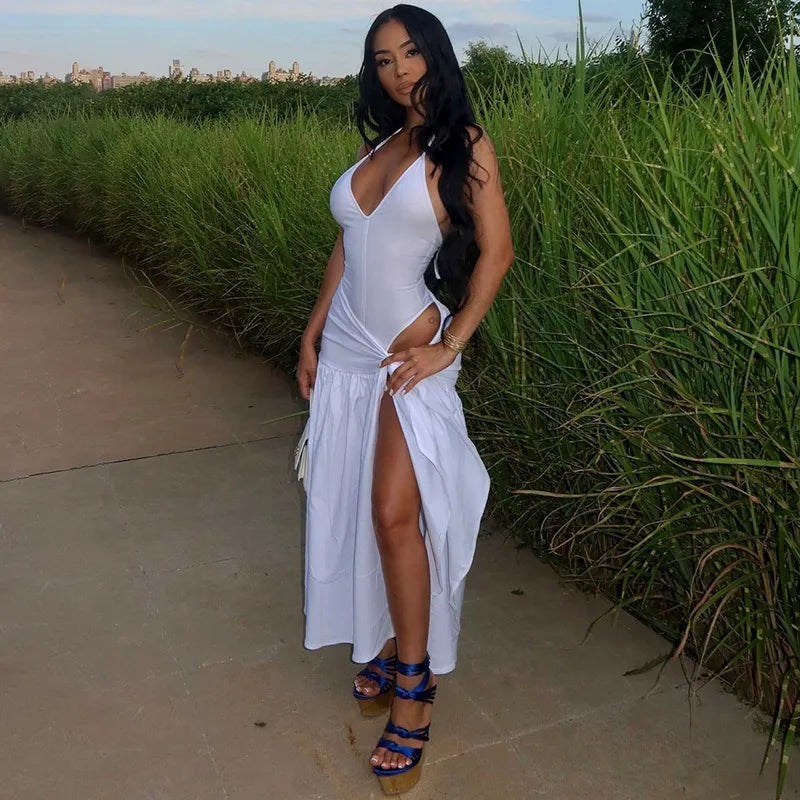 Woman in a white dress standing outdoors near greenery halter skirt set, two piece outfit women, skirt co ord set, matching set women, bodycon skirt set, sexy vacation outfit, halter neck outfit, asymmetrical outfit, date night outfit, clubwear women, birthday outfit women, resort wear women, vacation clothes women, slim fit skirt set, elegant two piece set, womens co ord set, sexy matching set, summer outfit women, luxury fashion women, trendy two piece outfit simsuit