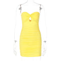 Yellow strapless dress on a mannequin against a white background