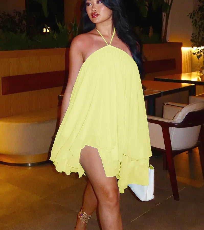 Woman in a yellow dress standing in an outdoor restaurant setting