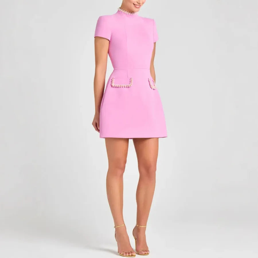 Pink dress with short sleeves and a plain background