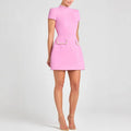 Pink dress with short sleeves and a plain background
