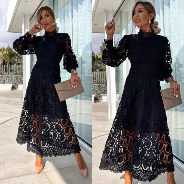 Woman wearing a black lace dress holding a beige clutch in front of a modern building.