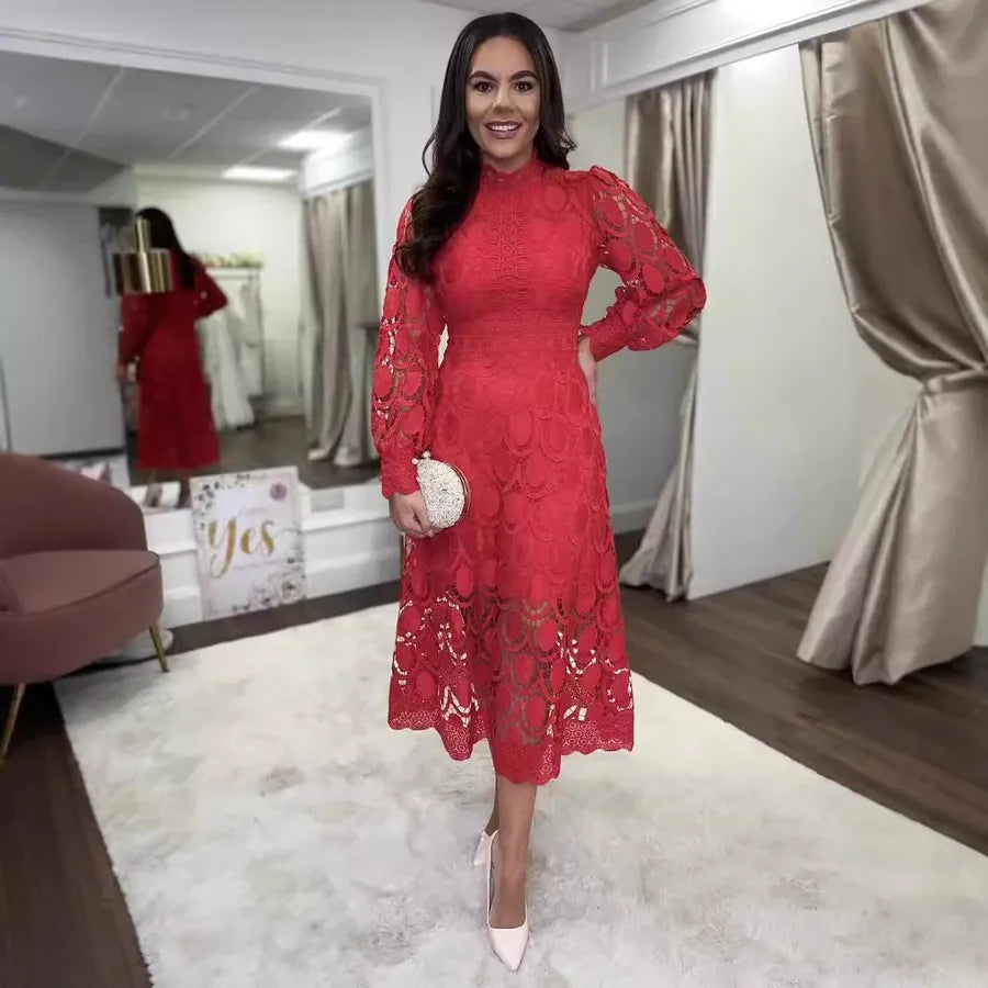 Woman wearing a red lace dress in a fitting room.