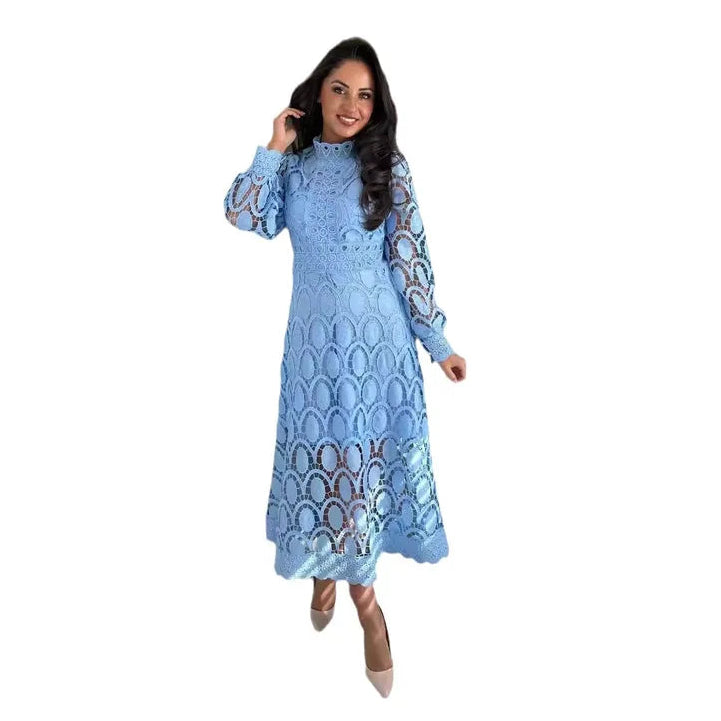 Woman wearing a blue dress with intricate patterns on a white background