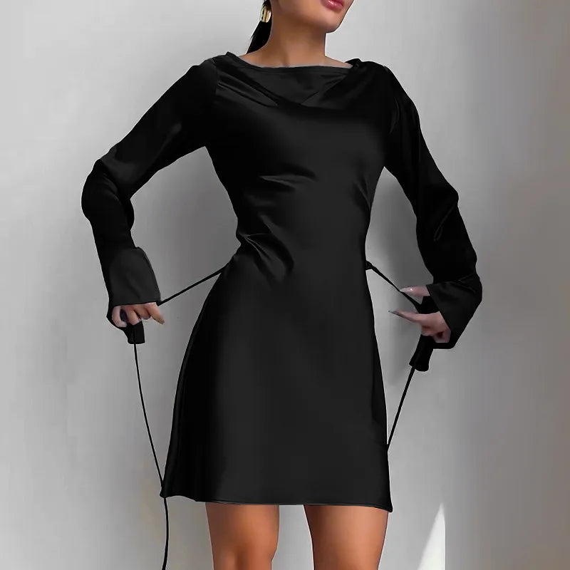 Black dress with long sleeves on a plain background