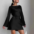 Black dress with long sleeves on a plain background