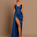 Woman wearing a blue evening gown with a high slit on a brown background