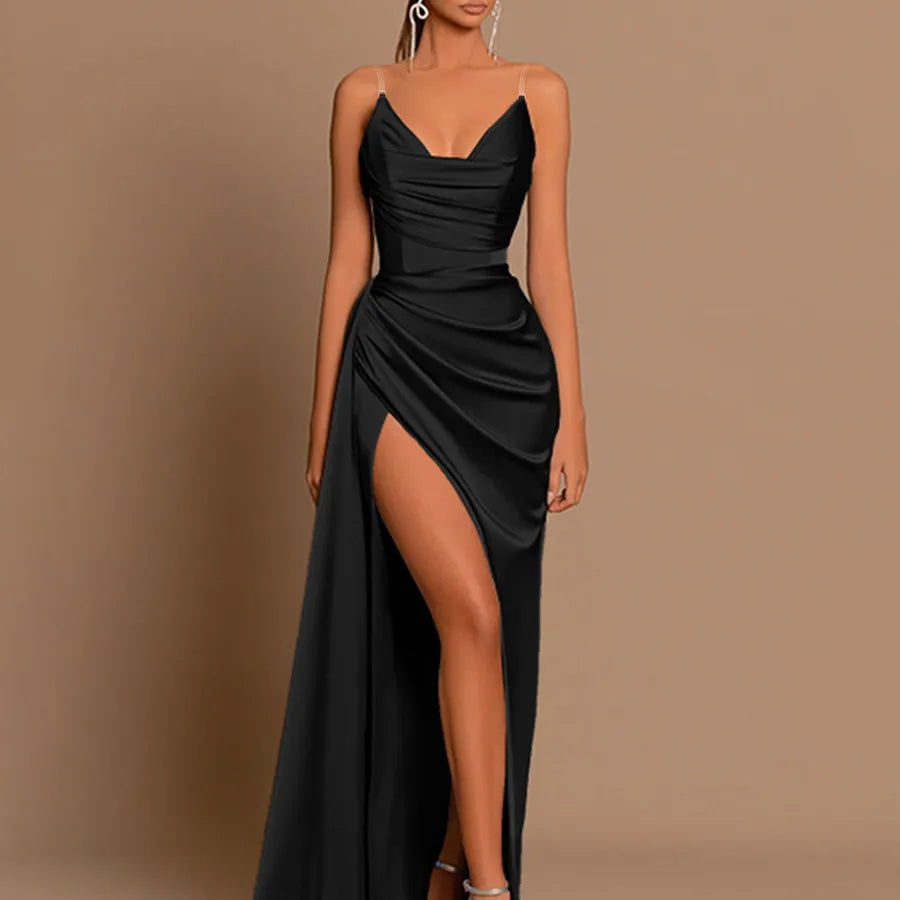 Black evening gown with a high slit on a brown background