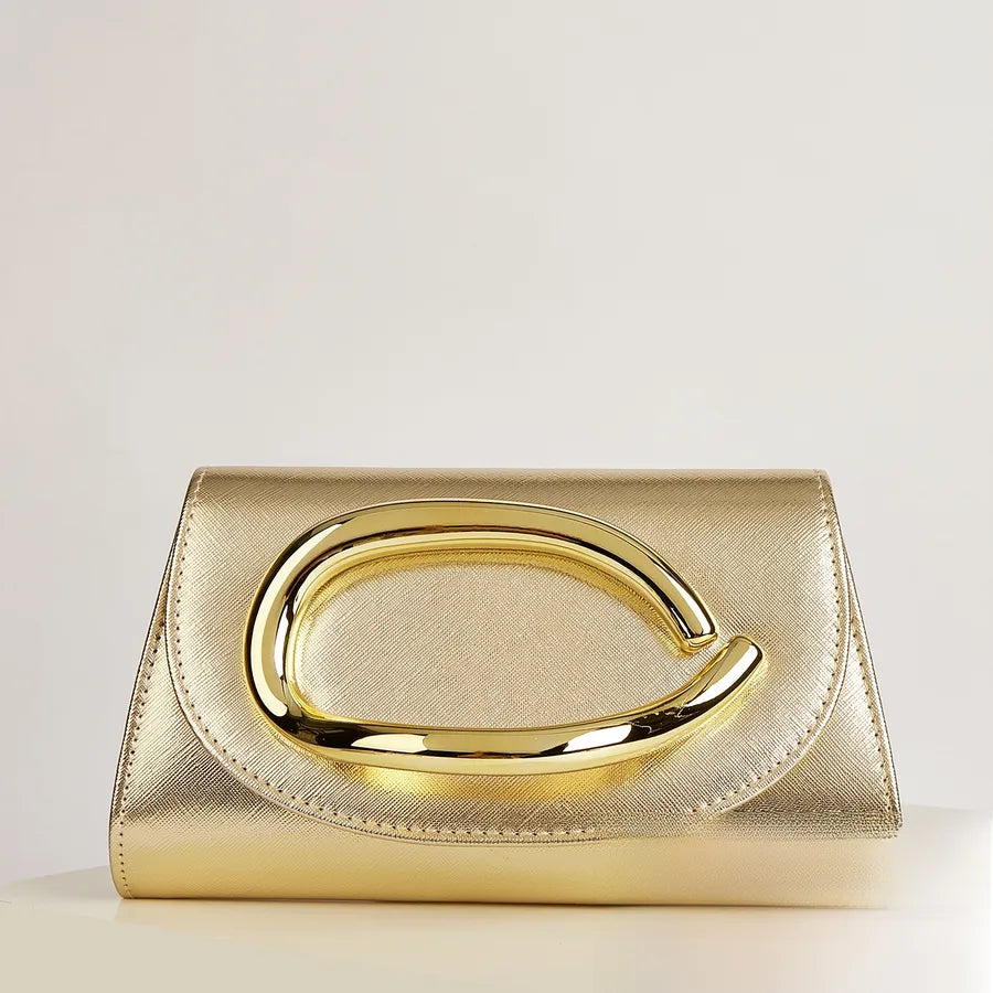 Gold clutch bag with a prominent handle on a light background