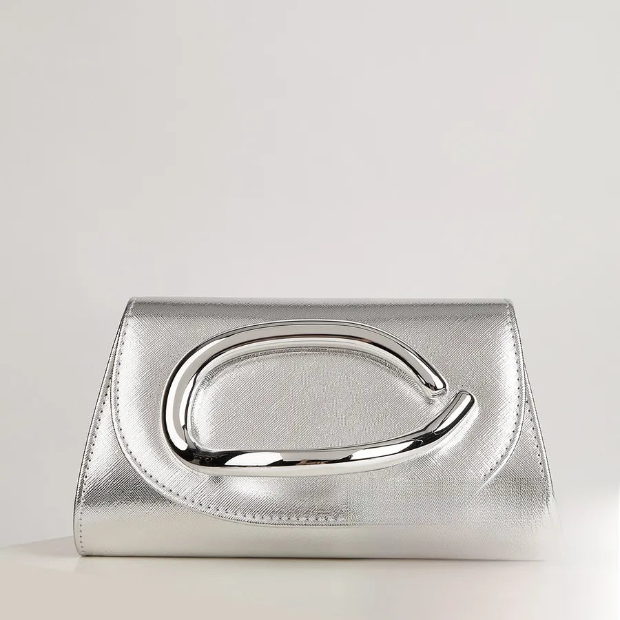 Silver clutch bag with a reflective handle on a light gray background